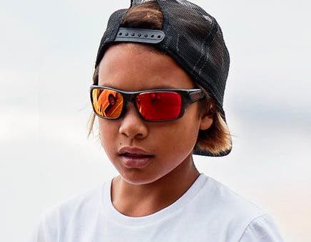 ”Kid wearing Oakley youth sunglasses on face